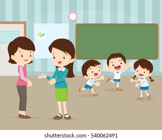 Parent Meeting With Teacher In Classroom.Pupils Playing And In Class.