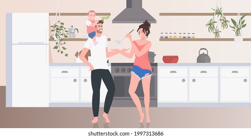 parents with little son preparing food family spending time together modern kitchen interior horizontal