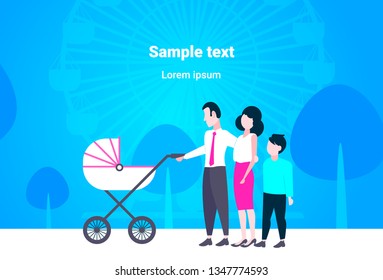 parents with son and baby in pram walking together in city urban park happy family father mother and children having fun outdoor ferris wheel landscape background full length flat copy space