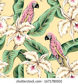 Parrots, green banana palm leaves, orchid flowers, yellow background. Vector floral seamless pattern. Tropical illustration. Exotic plants, birds. Summer beach design. Paradise nature