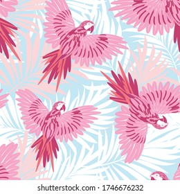 Parrots on the background of palm branches and leaves. Tropical seamless pattern. Vector image.