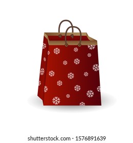 Party festive gift bag of red paper with golden ribbon decorated with a winter pattern of snowflakes isolated on a white background