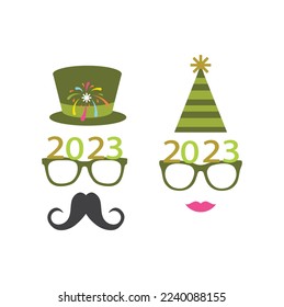 Party glasses and greetings decorated with a hat and stars in green, ready to be used in New Year's Eve party for 2023.