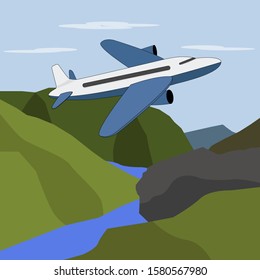 Passenger plane flies over the mountains.
A large plane flies over the mountain peaks and the river.