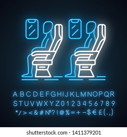 Passengers at plane salon neon light icon. Airplane comfortable seating. Jet relaxed travelers. Aircraft cabin. Glowing sign with alphabet, numbers and symbols. Vector isolated illustration