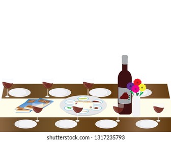 Passover seder table with Hagaddah, wine bottle and glasses and Seder plate