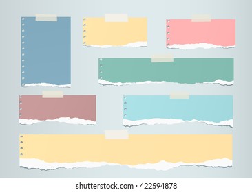 Pastel colorful ripped blank note paper are stuck on gray  background