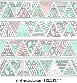 Pastel colors tribal vector seamless pattern with doodle triangles. Hand drawn. Aztec abstract geometric art print. Ethnic vector background.  Wallpaper, cloth design, fabric, tissue, textile template