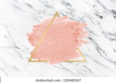 Pastel pink paint with a gold triangle frame on a white marble background vector