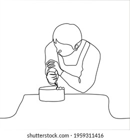 pastry chef decorates cake with cream - one line drawing. a man in an apron bent over a round cake with a pastry bag, he squeezes out the cream on the birthday cake