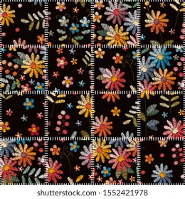 Patchwork seamless pattern from stitched square patterns with colorful embroidered flowers.