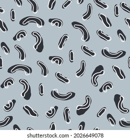 a patern of black speckled curves of corn sticks with white backing on a gray background
