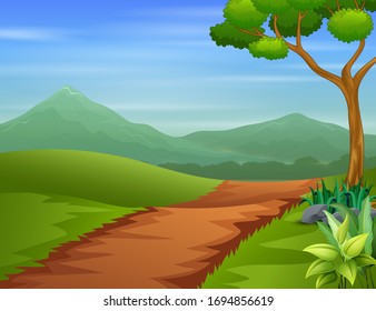 A pathway going through green outfield with tree and hills