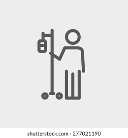 Patient standing with intravenous saline solution icon thin line for web and mobile, modern minimalistic flat design. Vector dark grey icon on light grey background.