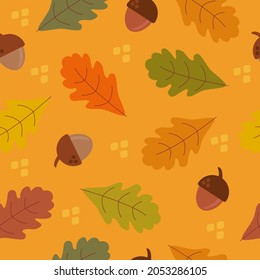 Pattern of acorns and autumn oak leaves of orange green yellow brown color on yellow background