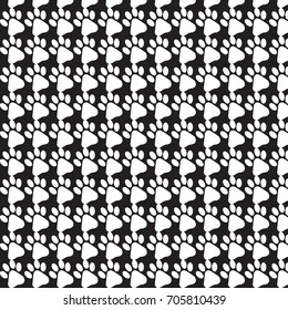 Pattern background of white dog's footprint on a black background.