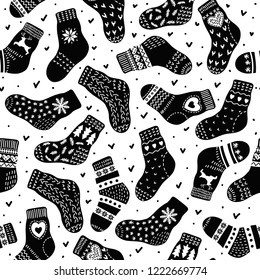 Pattern from black hand drawn cute warm socks on white background. Black and white vector illustration.