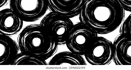 A pattern of black and white circular shapes with varying sizes, creating a dynamic and artistic design.