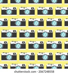 Pattern with cameras on yellow.  Can be used as a background. Repeating pattern of retro cameras.