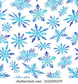 Pattern of Christmas snowflakes on a white background.Blue snowflakes in a pattern on a white background.