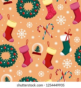 Pattern of Christmas stockings, wreaths with Christmas decorations, candy canes, snow balls and snowflakes