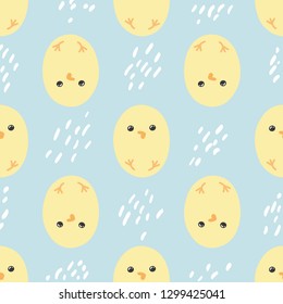 Pattern of cute yellow chickens on a blue background. Seamless.