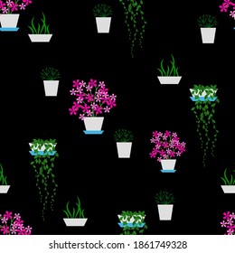Pattern of flowering and not blooming house plants on black background