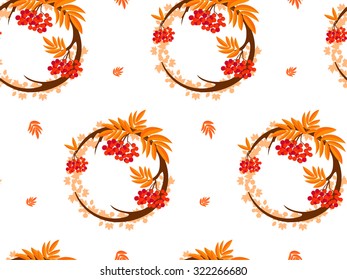 The pattern in the form of a circle formed by the branches and berries of rowan. The pattern in the autumn style on a white background. Also on the background can be seen maple leaves.