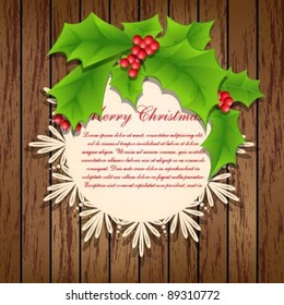 Pattern frame with holly berries on a wooden background