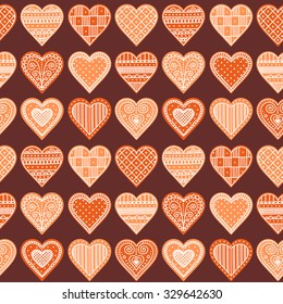 Pattern with gingerbread hearts. Cute Christmas background with hand drawn cookies. Seamless winter pattern. Brown colors.