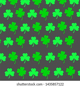 a pattern of green clovers on dark gray background