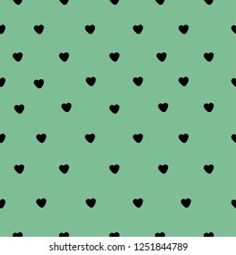 A pattern of hearts. Green background, little black hearts. Well suited for banner, packaging, postcards. Simple seamless pattern.