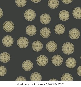 The pattern of the mandala in yellow on a black background arranged in a random order