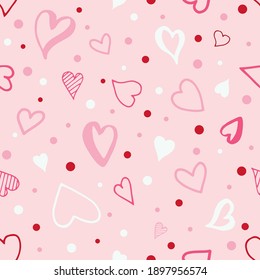 A pattern of red and white hearts and dots on a pink background