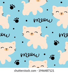 The pattern is seamless with cats on a blue background. Cute cartoon kittens