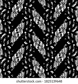 Pattern with short oblique stripes and mottled patches arranged alternately along some bands of mesh. Embroidery made graphically in black and white.