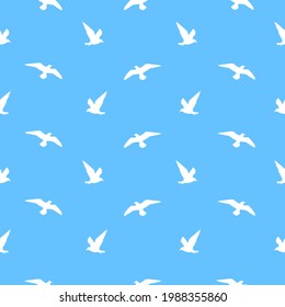 A pattern of silhouettes of Ivory gulls on a blue background. Vector flat illustration.