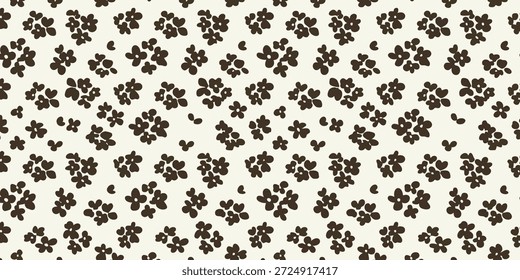 Un patrón de Pequeñas flores negras sobre un fondo blanco visto directamente desde arriba