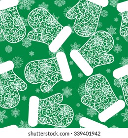 Pattern with snowflakes and mittens on green background