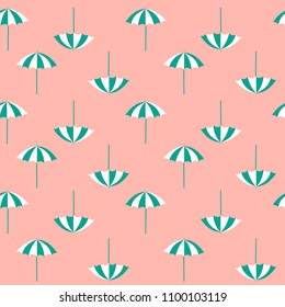 Pattern of summer beach umbrellas on pink background
