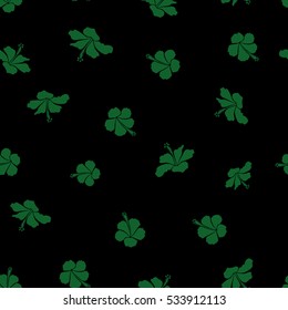 Pattern for summer fashion, interior, wallpaper. Seamless vector tropical design with hibiscus on a black background in green colors. Exotic flowers in allover composition.