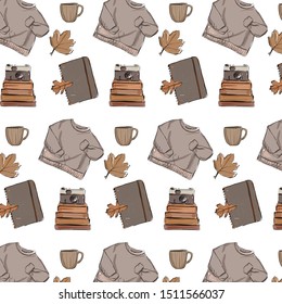 Pattern with sweater, stack of books, vintage camera, fallen autumn leaf, cup.
Hand drawn watercolor vector illustration. 