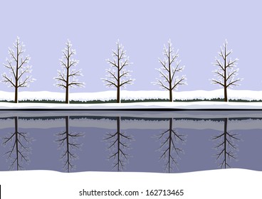 Pattern of winter landscape  with reflections of trees in calm water
