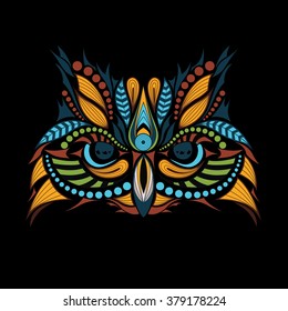 Patterned colored head of the owl on black. African / indian / totem / tattoo design. It may be used for design of a t-shirt, bag, postcard and poster.