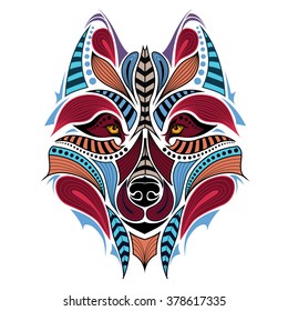 Patterned colored head of the wolf. African / indian / totem / tattoo design. It may be used for design of a t-shirt, bag, postcard and poster.