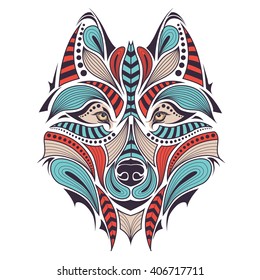 Patterned colored head of the wolf. African / indian / totem / tattoo design. It may be used for design of a t-shirt, bag, postcard and poster.