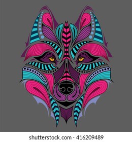 Patterned colored head of the wolf. African / indian / totem / tattoo design. It may be used for design of a t-shirt, bag, postcard and poster.