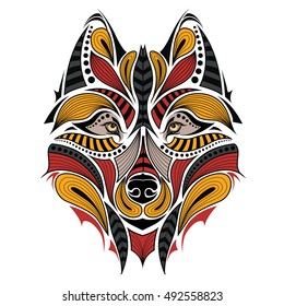 Patterned colored head of the wolf. African / indian / totem / tattoo design. It may be used for design of a t-shirt, bag, postcard and poster.