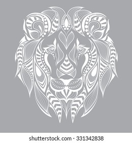 Patterned head of the lion on the grey background. African / indian / totem / tattoo design. It may be used for design of a t-shirt, bag, postcard and poster.
