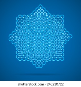 Patterned vector snowflake on a blue background with shadow